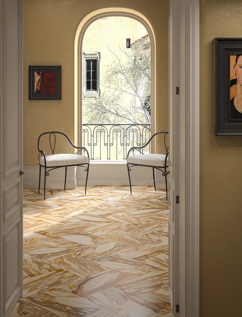 The stone laid as a floor across an entrance hall, cut into panels and set so the figure runs from one to the next.